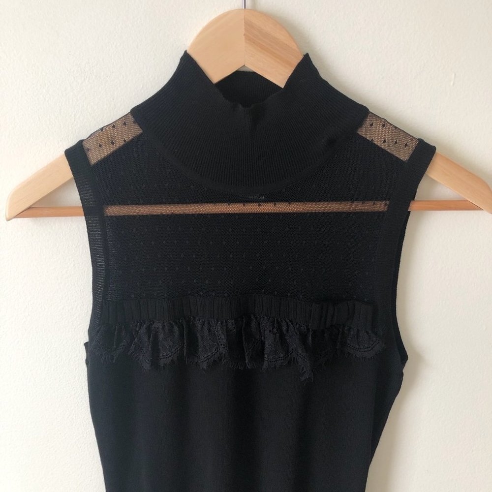 Elegant Sleeveless top with mesh top and ruffle.